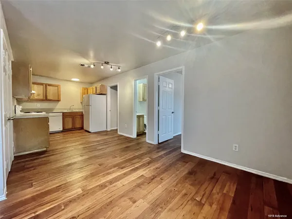a view of a kitchen with a sink and a refrigerator