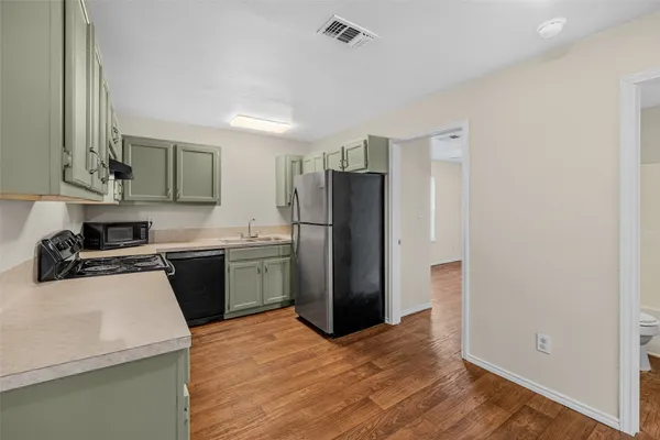 a kitchen with a refrigerator sink and stove