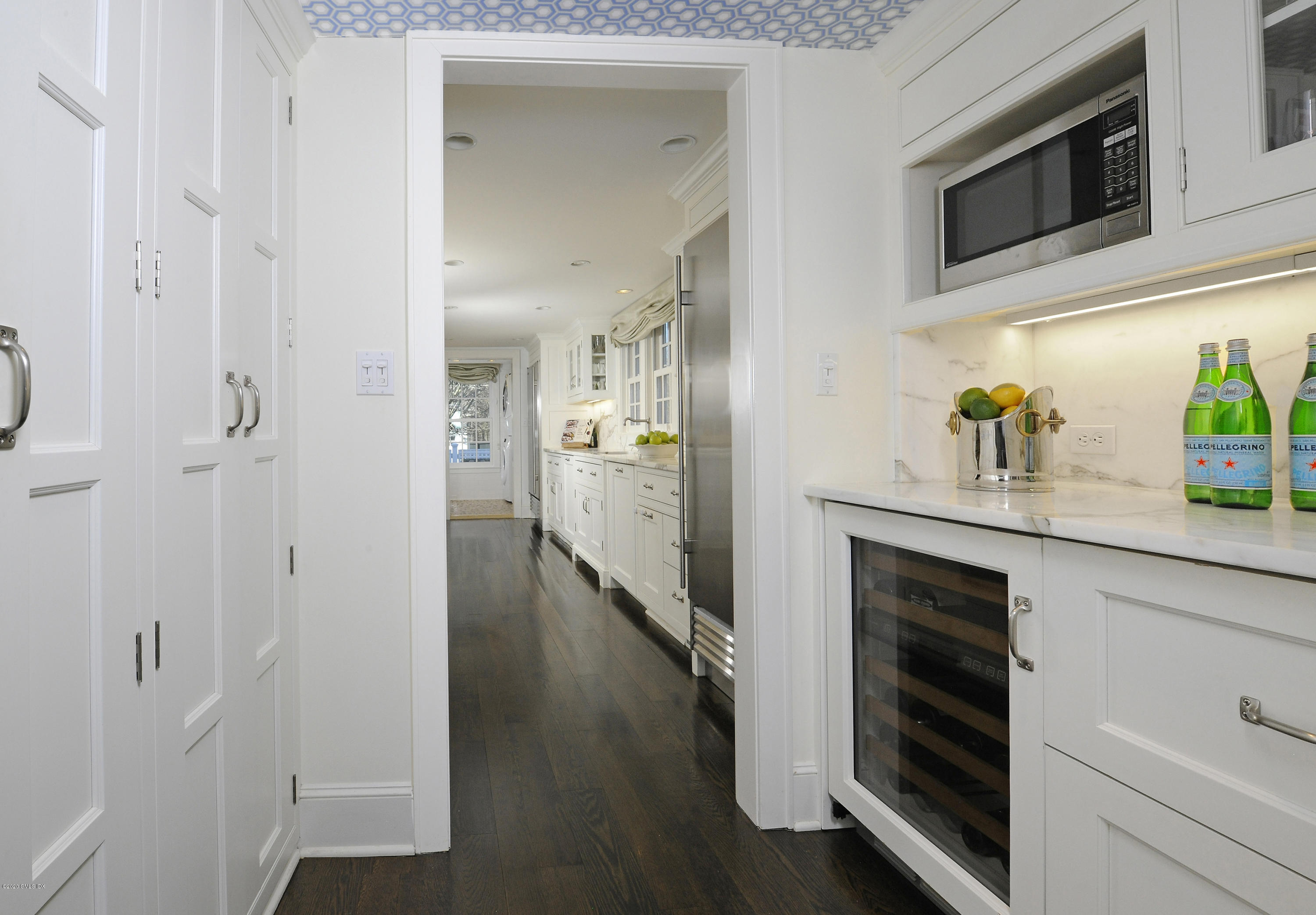 176 Stanwich Road Greenwich, CT 06830 - Photo 17 of 29 a kitchen with stainless steel appliances white cabinets and a wooden floor