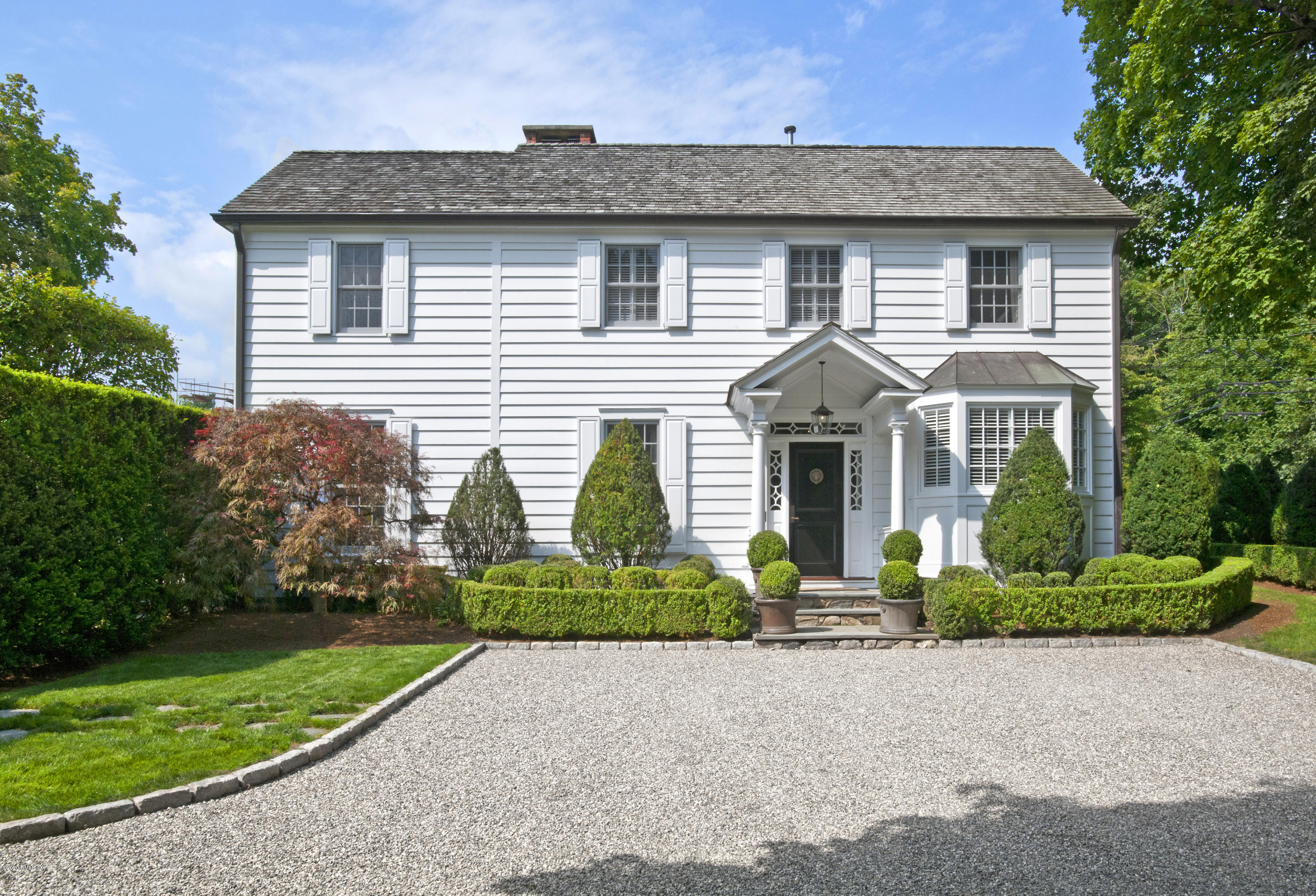 176 Stanwich Road Greenwich, CT 06830 - Photo 2 of 29 a front view of a house with a yard
