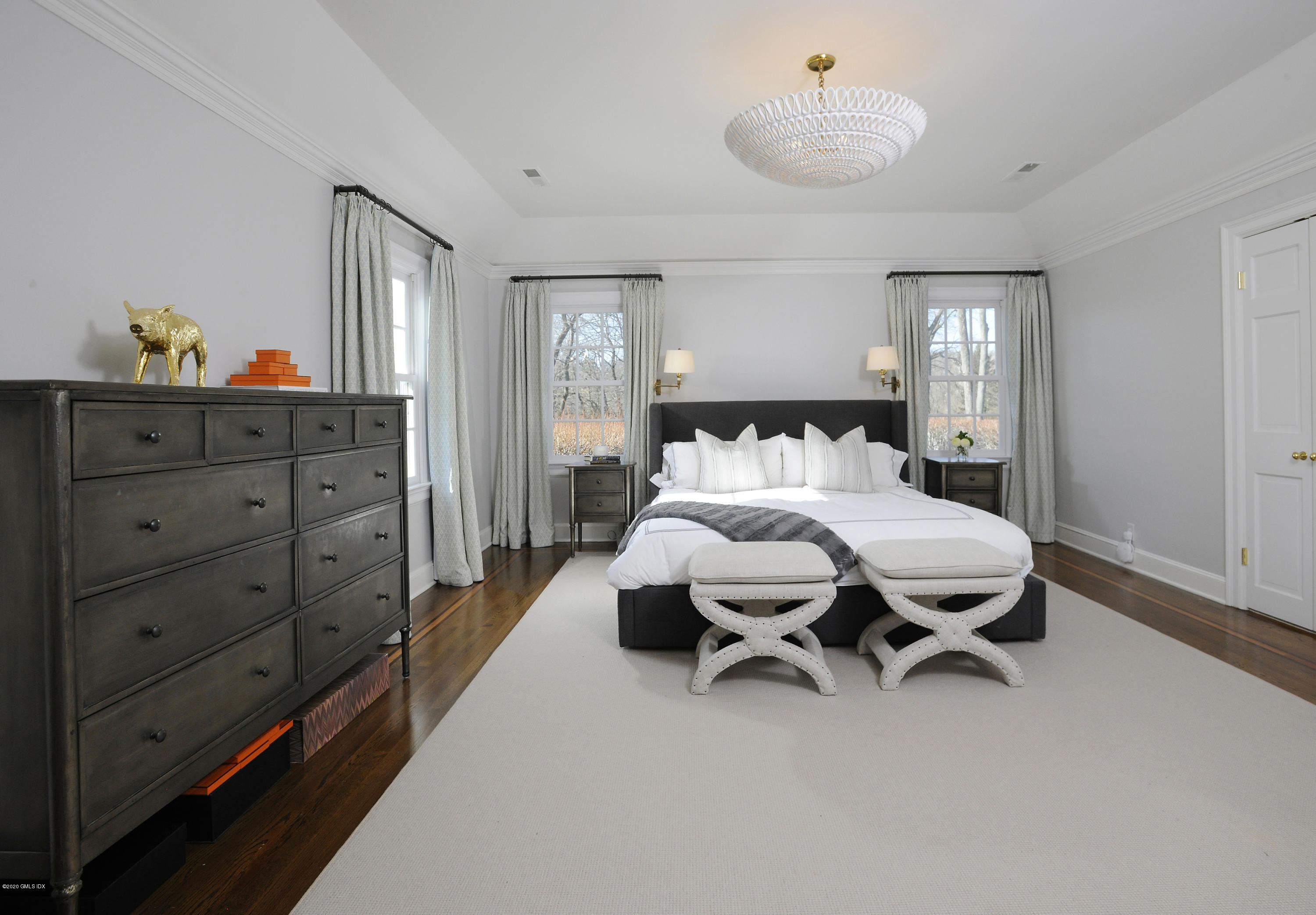 176 Stanwich Road Greenwich, CT 06830 - Photo 23 of 29 a bedroom with a bed and a chandelier