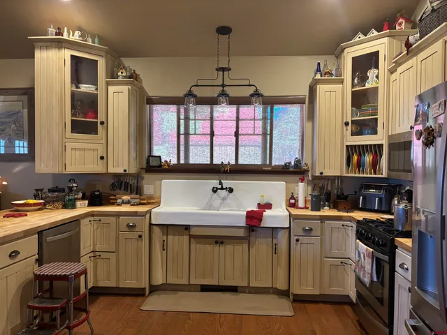 a kitchen with a sink stove and cabinets