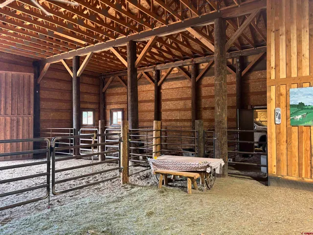a porch with a table and chairs and wooden floor