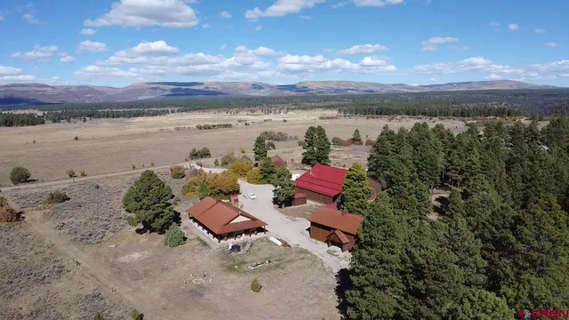 a view of a lake with a table chairs and a fire pit