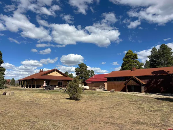 a view of a house with yard and a garden