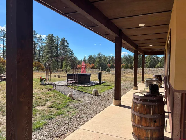 a view of a porch with furniture and a yard