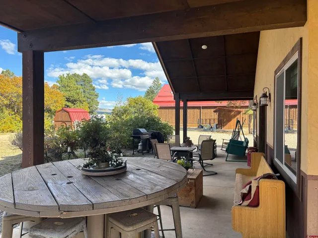 a view of a patio with dining table and chairs