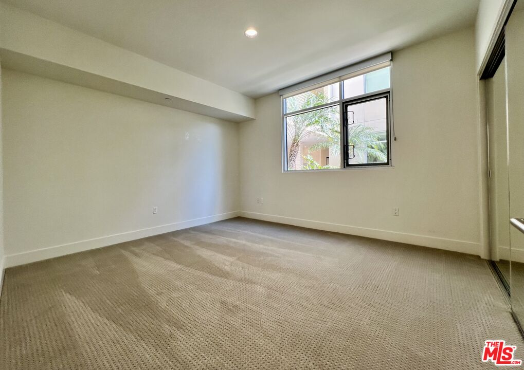 11715 Bellagio Road, Unit 104 Los Angeles, CA 90049 - Photo 12 of 25 an empty room with a window
