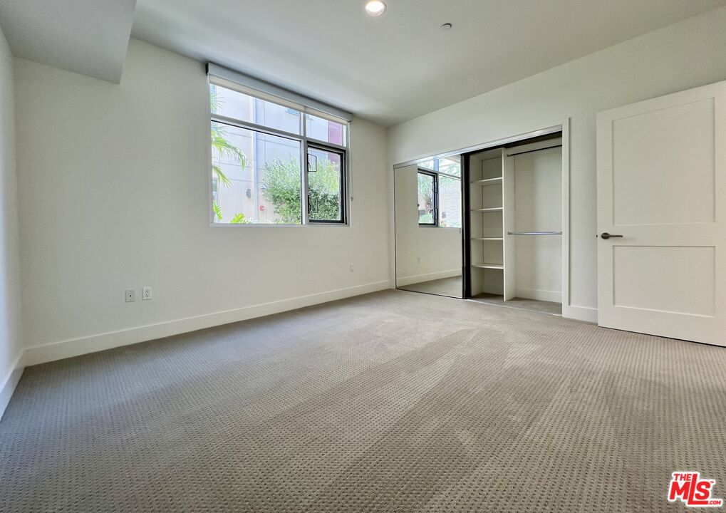 11715 Bellagio Road, Unit 104 Los Angeles, CA 90049 - Photo 13 of 25 an empty room with windows