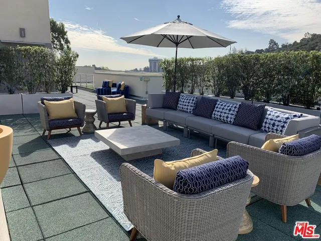 a view of a patio with couches chairs and a potted plant