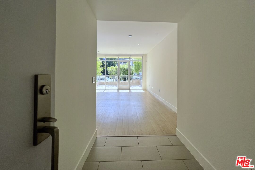 11715 Bellagio Road, Unit 104 Los Angeles, CA 90049 - Photo 2 of 25 a view of hallway with a window