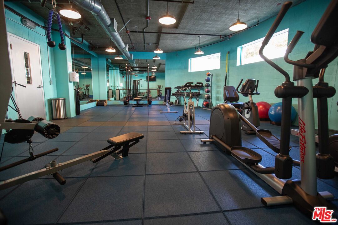 11715 Bellagio Road, Unit 104 Los Angeles, CA 90049 - Photo 24 of 25 a room with lots of gym equipment