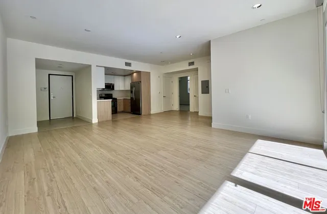 a view of a kitchen with wooden floor