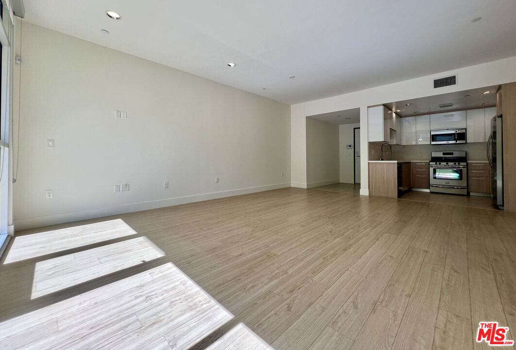 11715 Bellagio Road, Unit 104 Los Angeles, CA 90049 - Photo 7 of 26 a view of a livingroom with a furniture