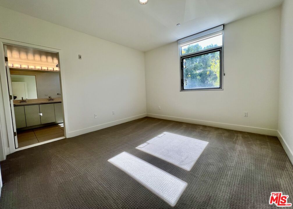 11715 Bellagio Road, Unit 104 Los Angeles, CA 90049 - Photo 8 of 26 an empty room with a bathroom