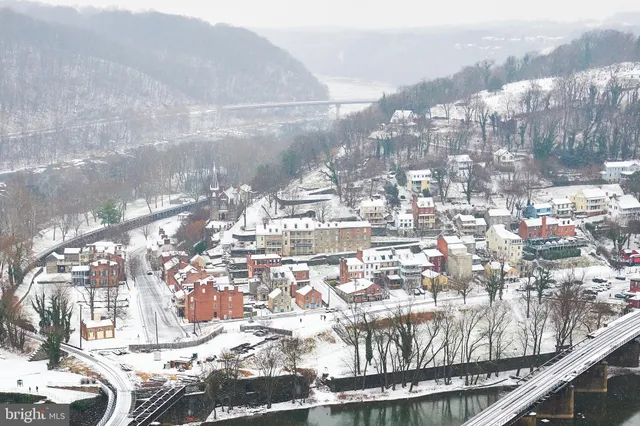 an aerial view of a house with a mountain