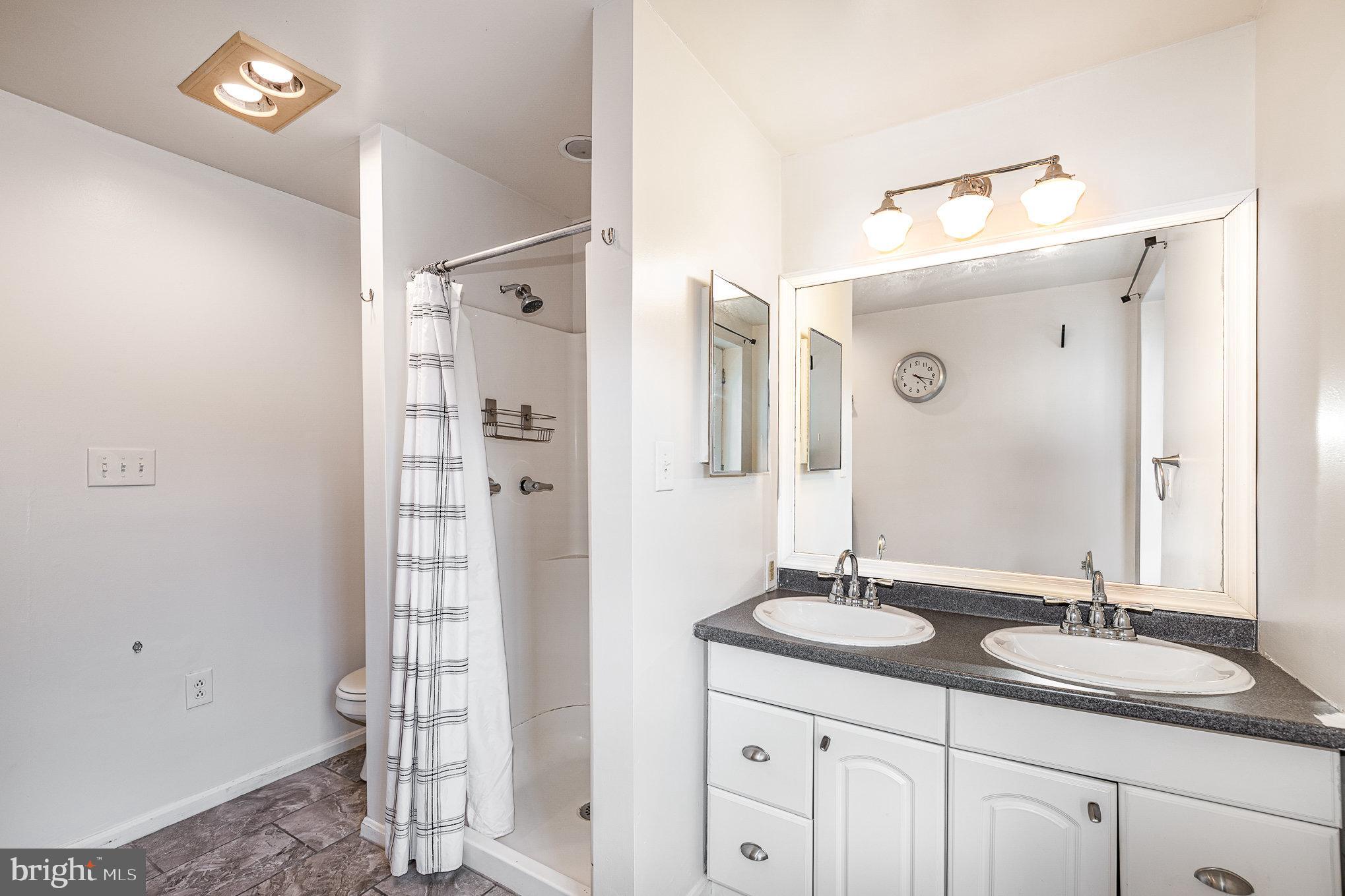 664 Washington Boulevard Baltimore, MD 21230 - Photo 16 of 30 a bathroom with a sink double vanity and a mirror