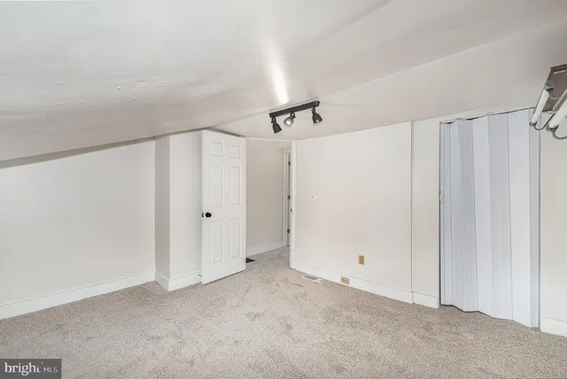a view of a room with a ceiling fan and window