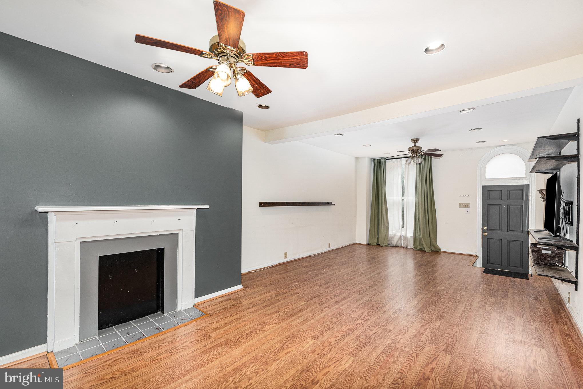 664 Washington Boulevard Baltimore, MD 21230 - Photo 3 of 30 a view of a livingroom with a fireplace and wooden floor