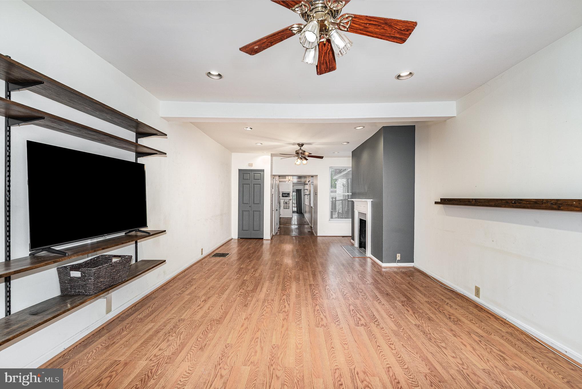 664 Washington Boulevard Baltimore, MD 21230 - Photo 4 of 30 a view of a livingroom with wooden floor and a flat screen tv