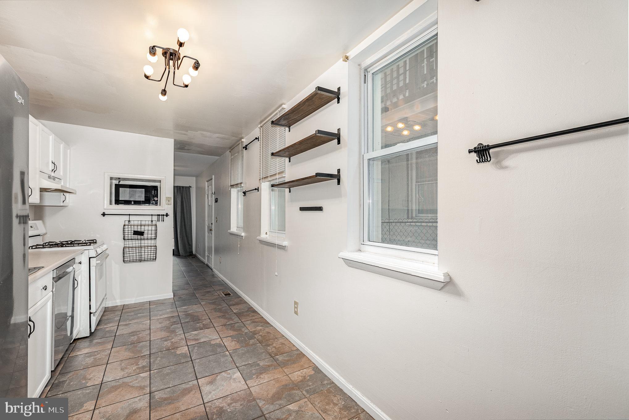 664 Washington Boulevard Baltimore, MD 21230 - Photo 7 of 30 a kitchen with stainless steel appliances a refrigerator and a stove top oven
