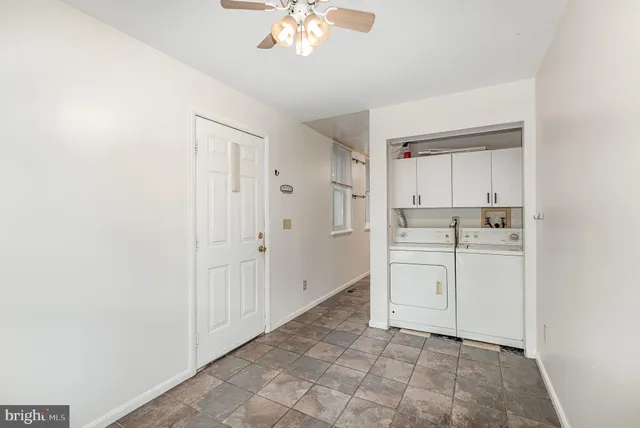 a view of a kitchen with white cabinets