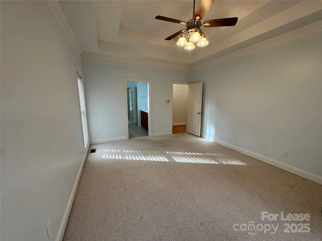 a view of a livingroom with a ceiling fan and window