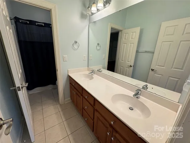 a spacious bathroom with a sink and a mirror