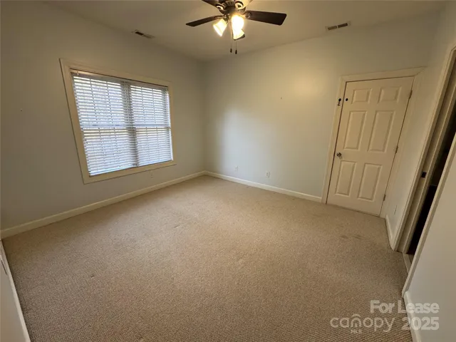 a view of a room with a ceiling fan