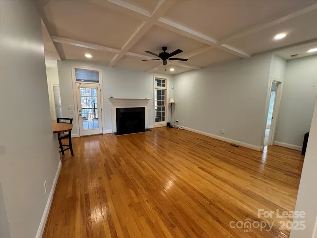 wooden floor in an empty room with a fireplace
