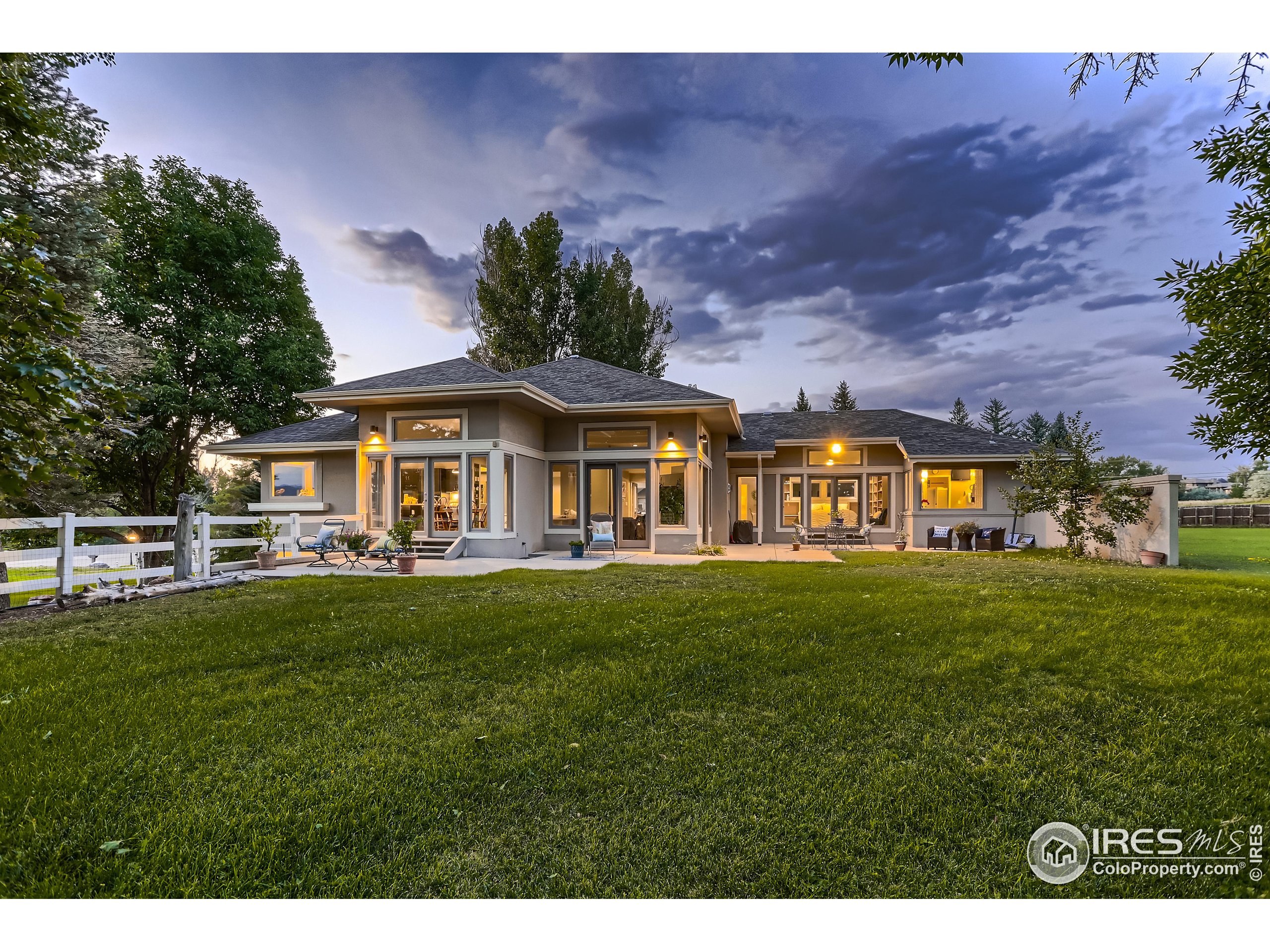 6400 Monarch Park Court Niwot, CO 80503 - Photo 1 of 40 a view of a house with a yard table and chairs