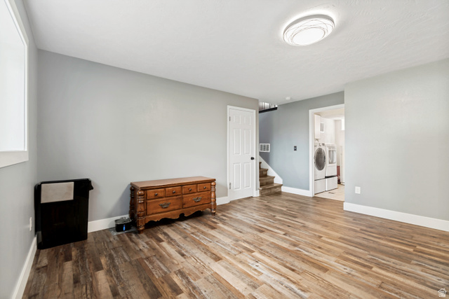 332 East Magellan Lane Elk Ridge, UT 84651 - Photo 14 of 24 Spacious room featuring wood-finish flooring, light gray walls, and white trim