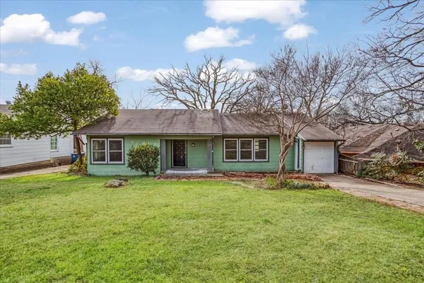 a backyard of a house with table and chairs