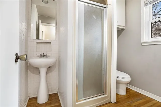 a bathroom with a sink toilet and a mirror