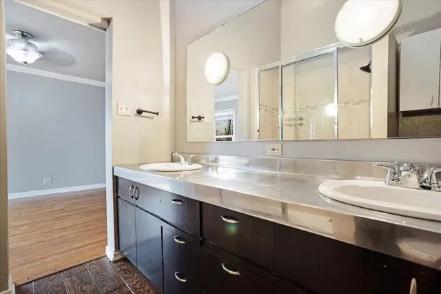a bathroom with a double vanity sink and a mirror