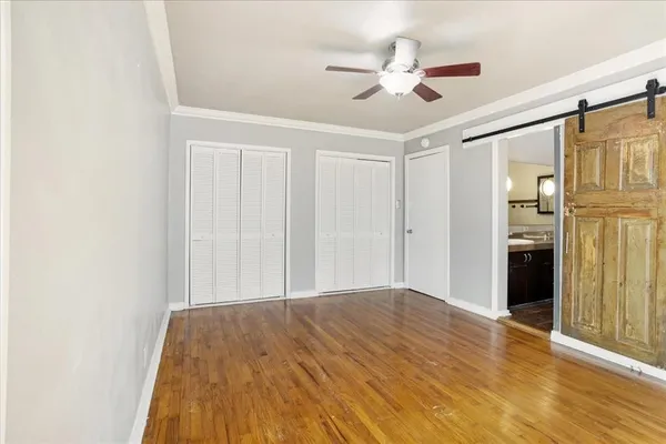 a view of empty room with wooden floor