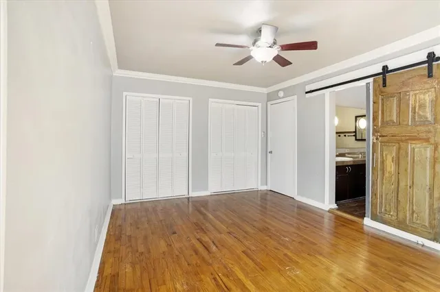 a view of empty room with wooden floor