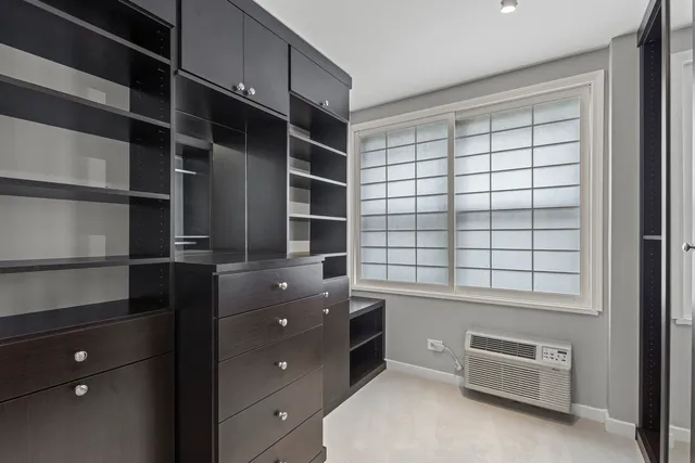 a view of walk in closet and window