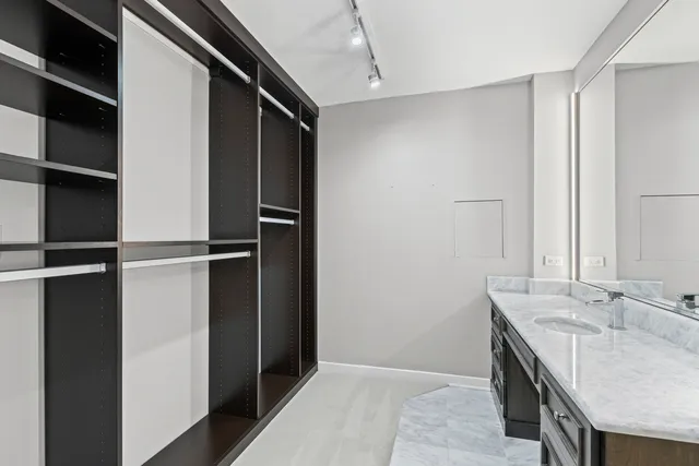 a bathroom with a granite countertop sink shower and a mirror