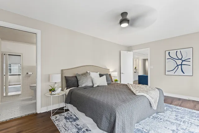 a bedroom with a bed and wooden floor