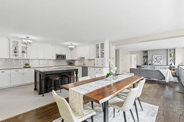 a large kitchen with a table and chairs