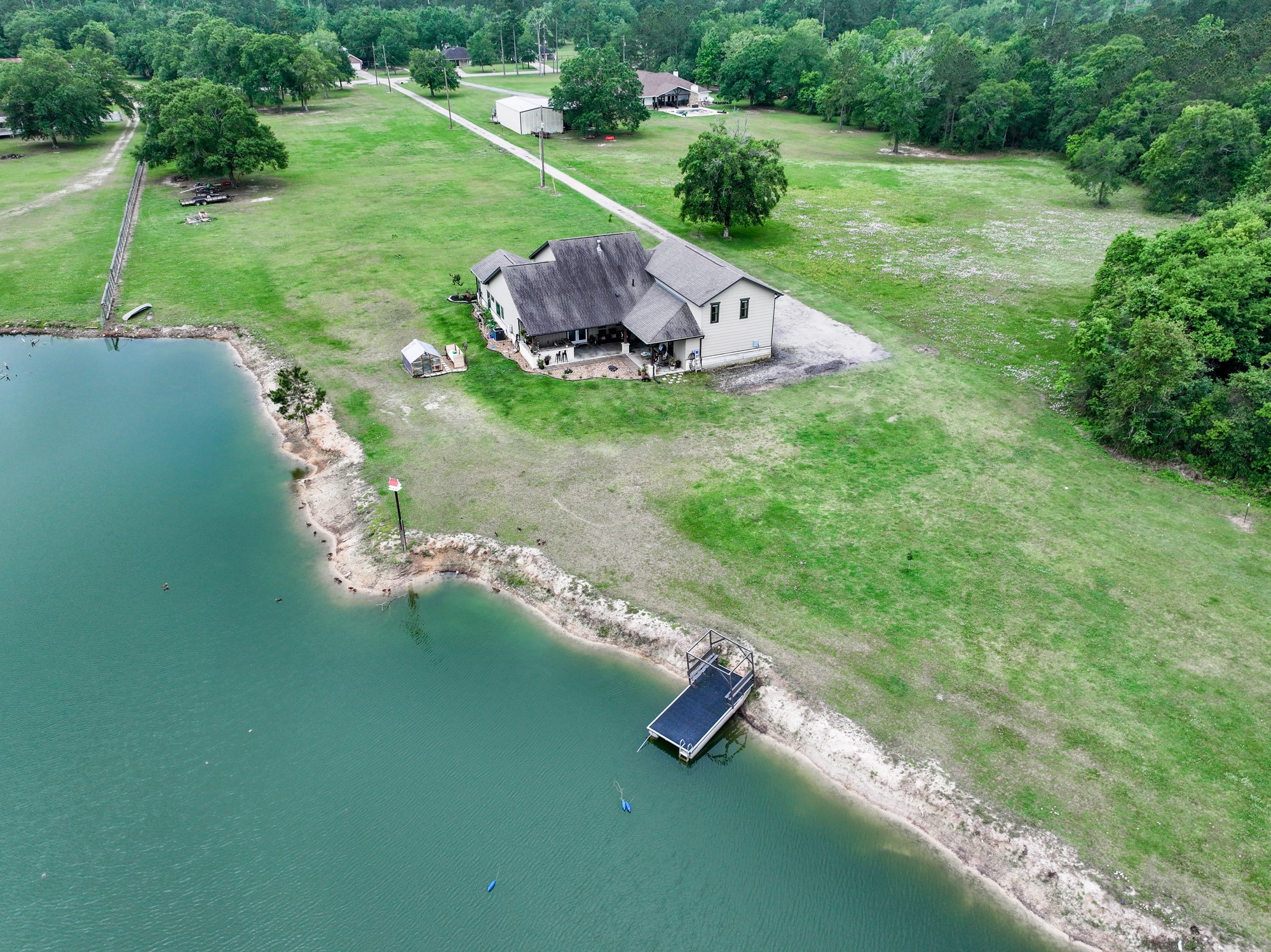 10573 Cooks Lake Road Lumberton, TX 77657 - Photo 42 of 47 a view of a backyard with table and chairs and a lake view