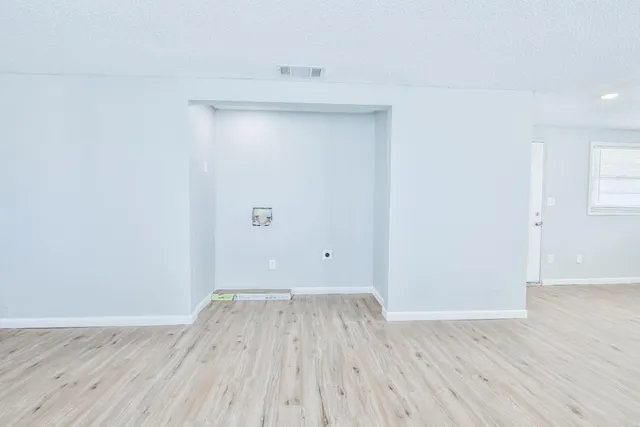 a view of a room with wooden floor