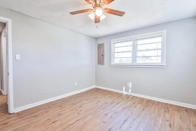 wooden floor in an empty room with a window