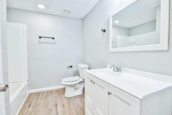 a bathroom with a sink toilet and a mirror