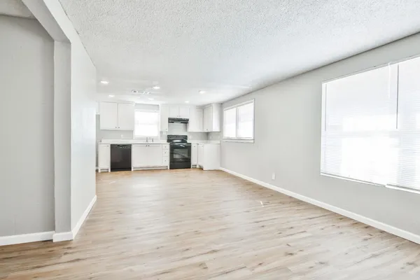 a view of a kitchen with a sink and a stove top oven