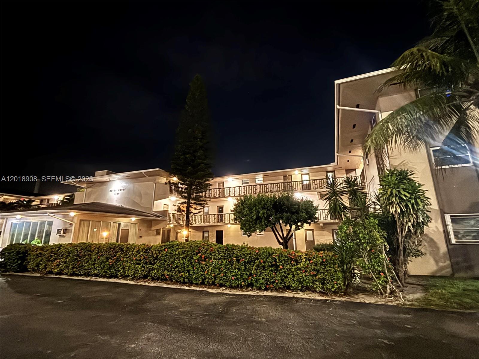1480 East Sample Road, Unit 209 Pompano Beach, FL 33064 - Photo 1 of 24 a front view of a house with a yard