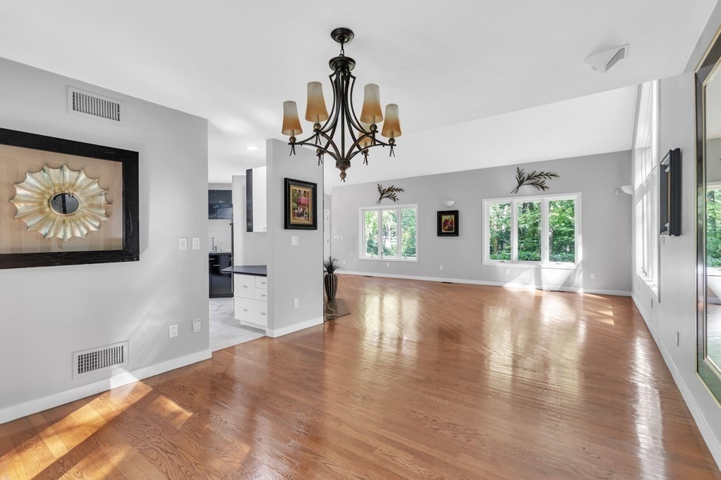 62 Chestnut Street Upton, MA 01568 - Photo 11 of 36 a view of a big room with wooden floor and windows
