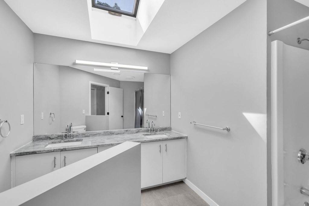 62 Chestnut Street Upton, MA 01568 - Photo 19 of 36 a bathroom with a granite countertop sink and a mirror