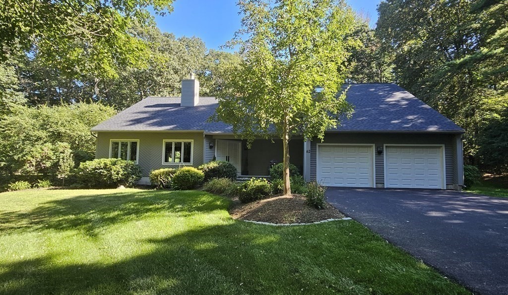 62 Chestnut Street Upton, MA 01568 - Photo 2 of 36 a front view of a house with a garden and yard